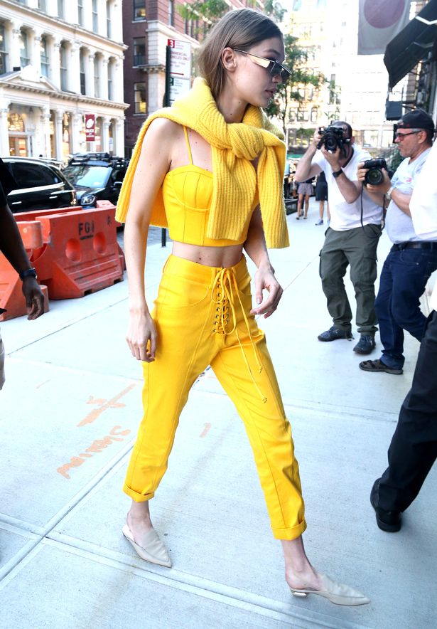 Gigi Hadid cuts a slender frame in preppy bright yellow outfit