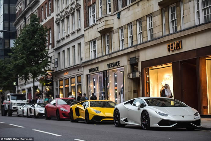 A row of stunning supercars line up outside designer shops Versace and Fendi in Sloane Street, west London