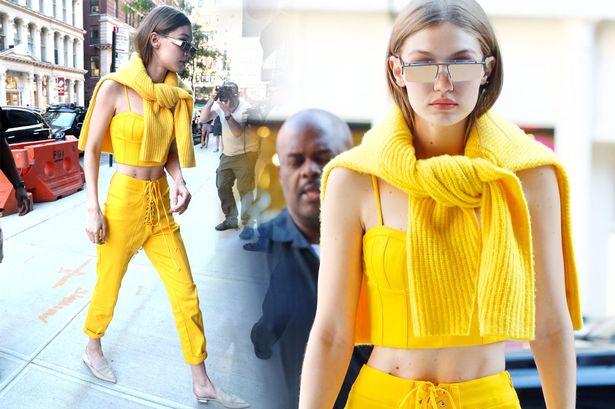 Gigi Hadid cuts a slender frame in preppy bright yellow outfit