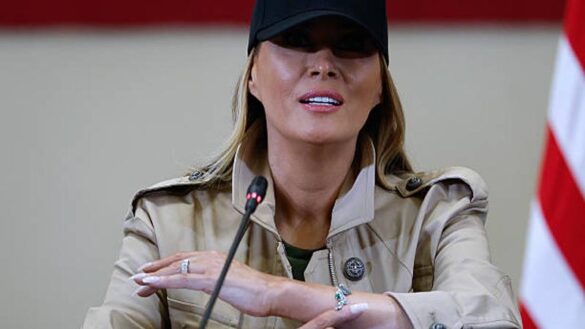 First Lady Melania Trump displays a bracelet she says was given to her in memory of the girls killed in last week's flash flood. (Photo by Chip Somodevilla/Getty Images)